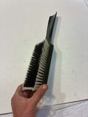 This is a vintage Swank clothing brush with a wooden shoe horn handle, made in W